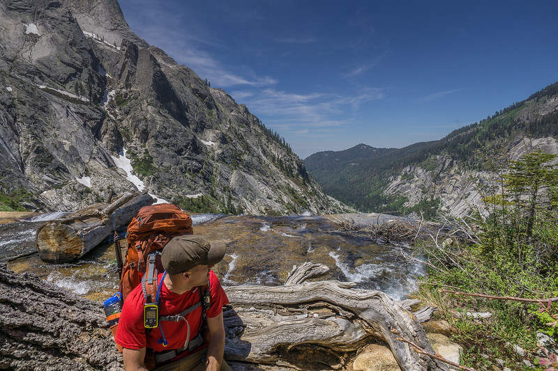 Backpacker beside the waterfall crossing below Hamilton Lake