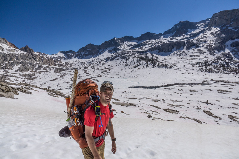 Backpacker descending into the snowy Big Arroyo basin