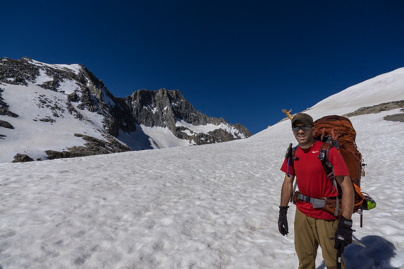 Backpacker crossing the snowy basin through Kaweah Gap