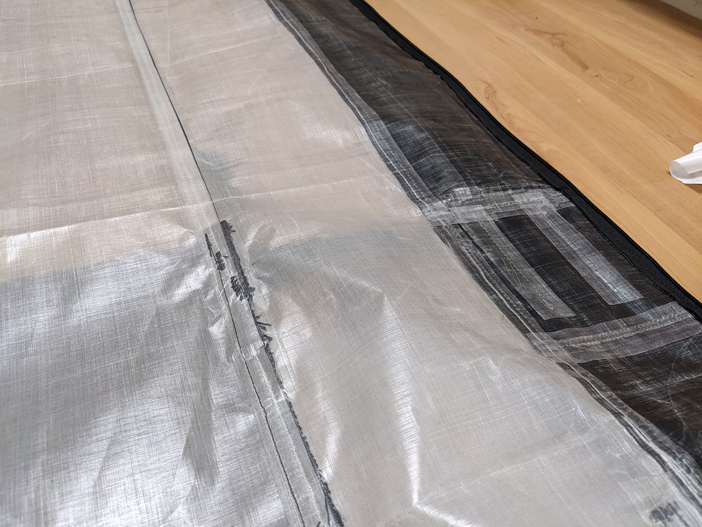 seam-sealing.jpg Seam-sealing tape applied over the backpack's interior stitched seams