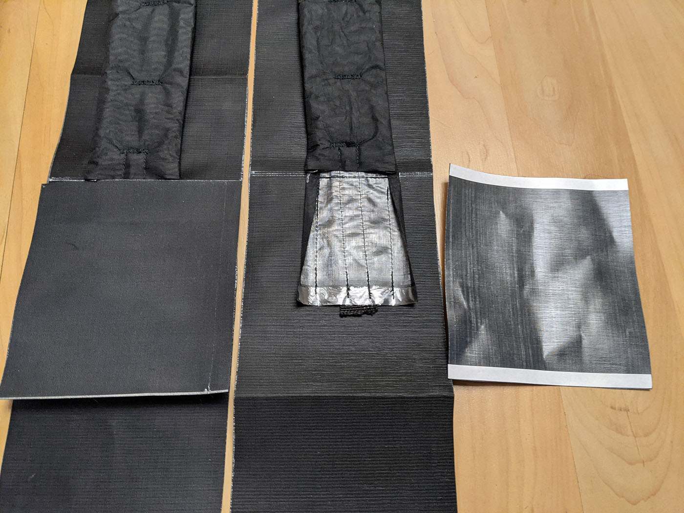 attach-myog-shoulder-straps.jpg Shoulder strap padding, webbing, and fabric layers laid out for assembly
