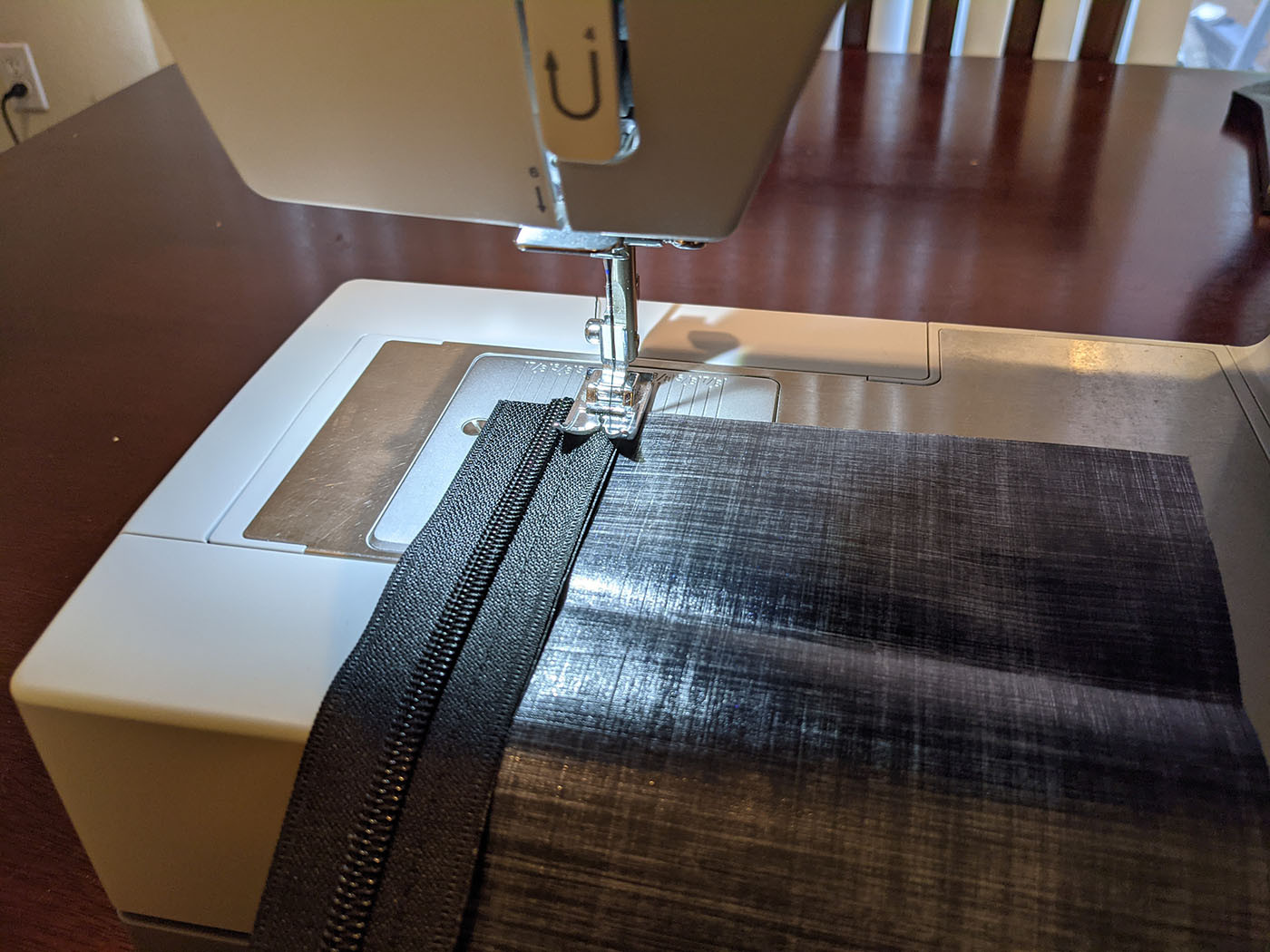 sewing-myog-zipper.jpg Sewing the full-length zipper onto the black Dyneema back panel