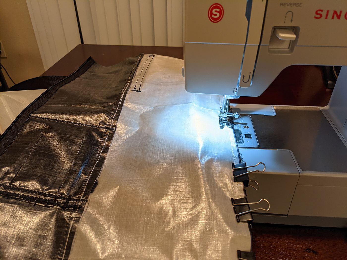 sewing-it-all-together.jpg Sewing a white Dyneema body panel to the black back panel