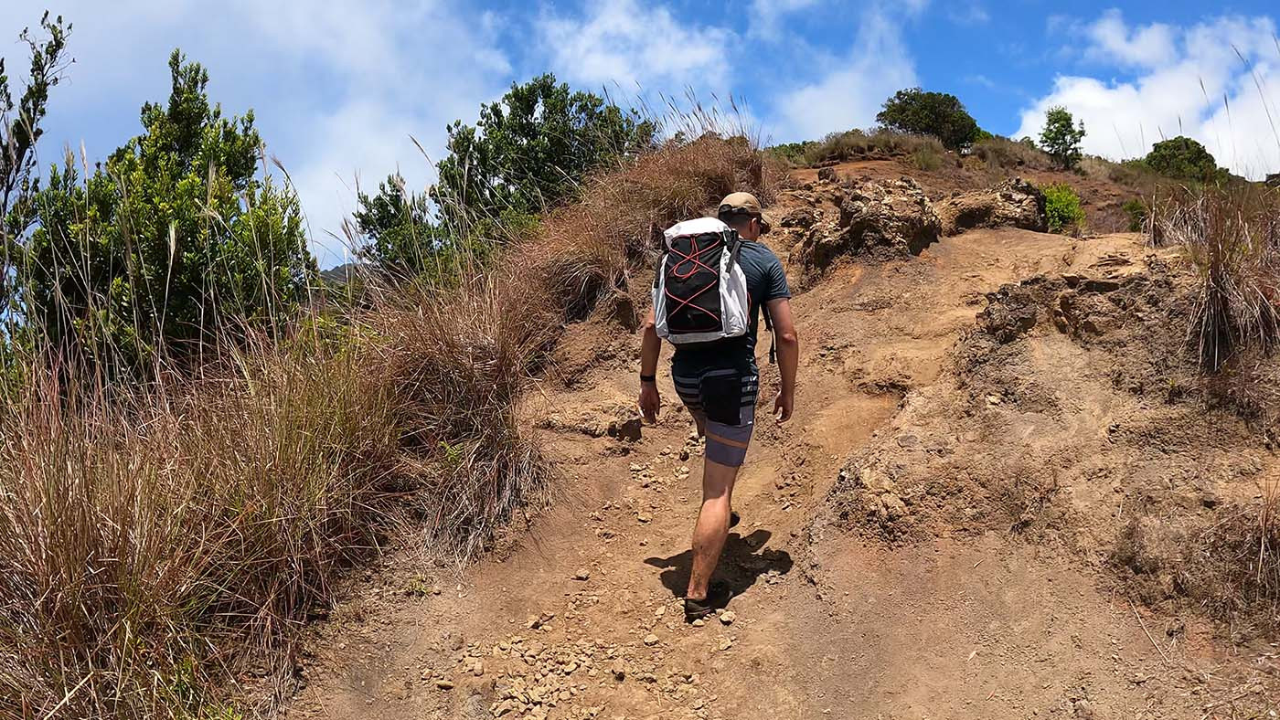 myog-backpack-test-2.jpg Hiker carrying the homemade backpack up a steep rocky trail