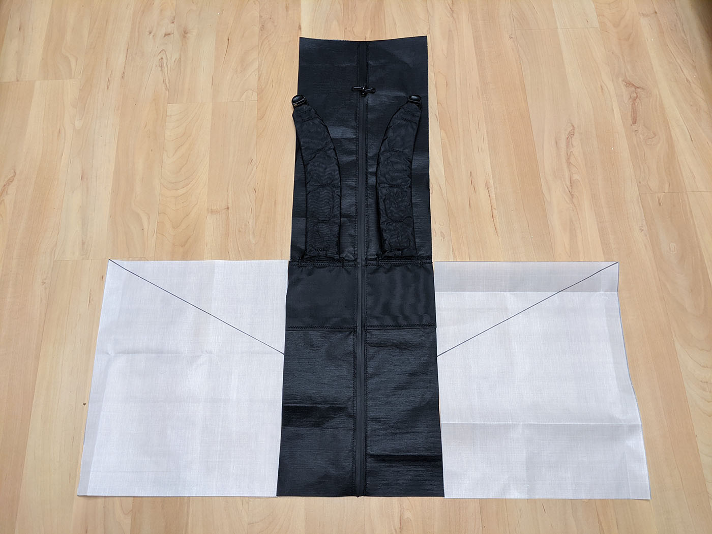 side-pockets-cutout.jpg Back panel and white side panels laid flat before pocket assembly
