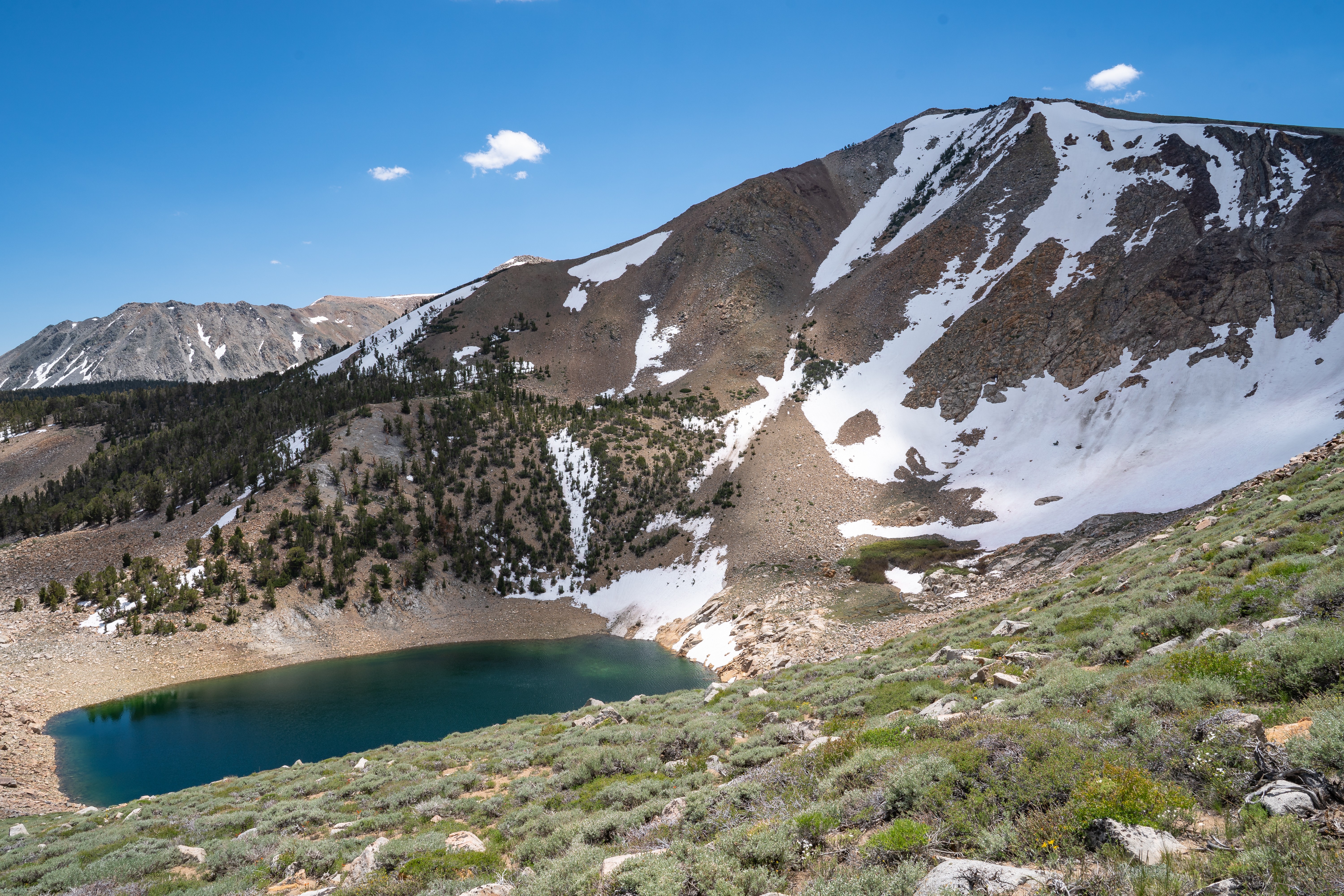 mcj07851.jpeg Deep blue alpine lake below a steep snow-streaked mountain cirque