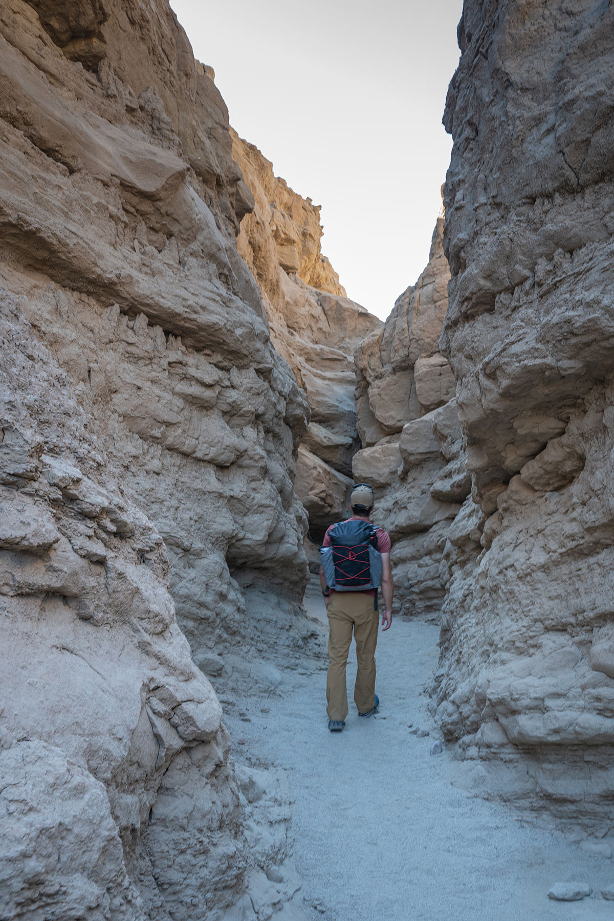 slot-canyon-shade.jpg Hiker walking in the shade between the tall walls of The Slot