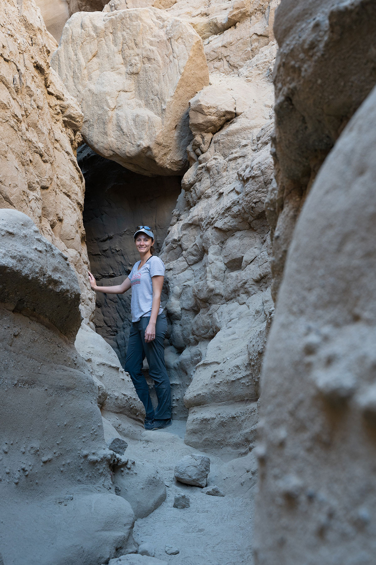 slot-canyon-falling-rock-1.jpg Hiker beneath a large boulder wedged high in The Slot canyon
