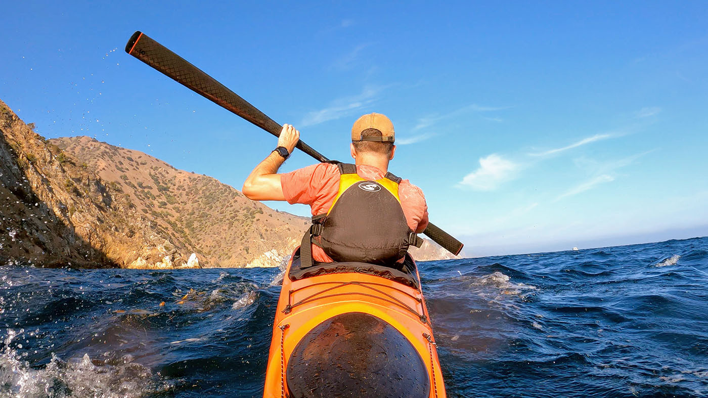 catalina-kayaking-big-wave.jpg Kayaker paddling an orange Pakayak through rolling waves off Catalina Island