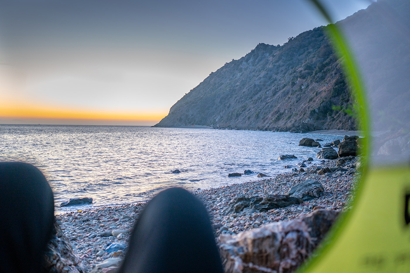 catalina-island-beach-camping-sunset.jpg Sunset over the rocky Catalina coast viewed from inside the tent