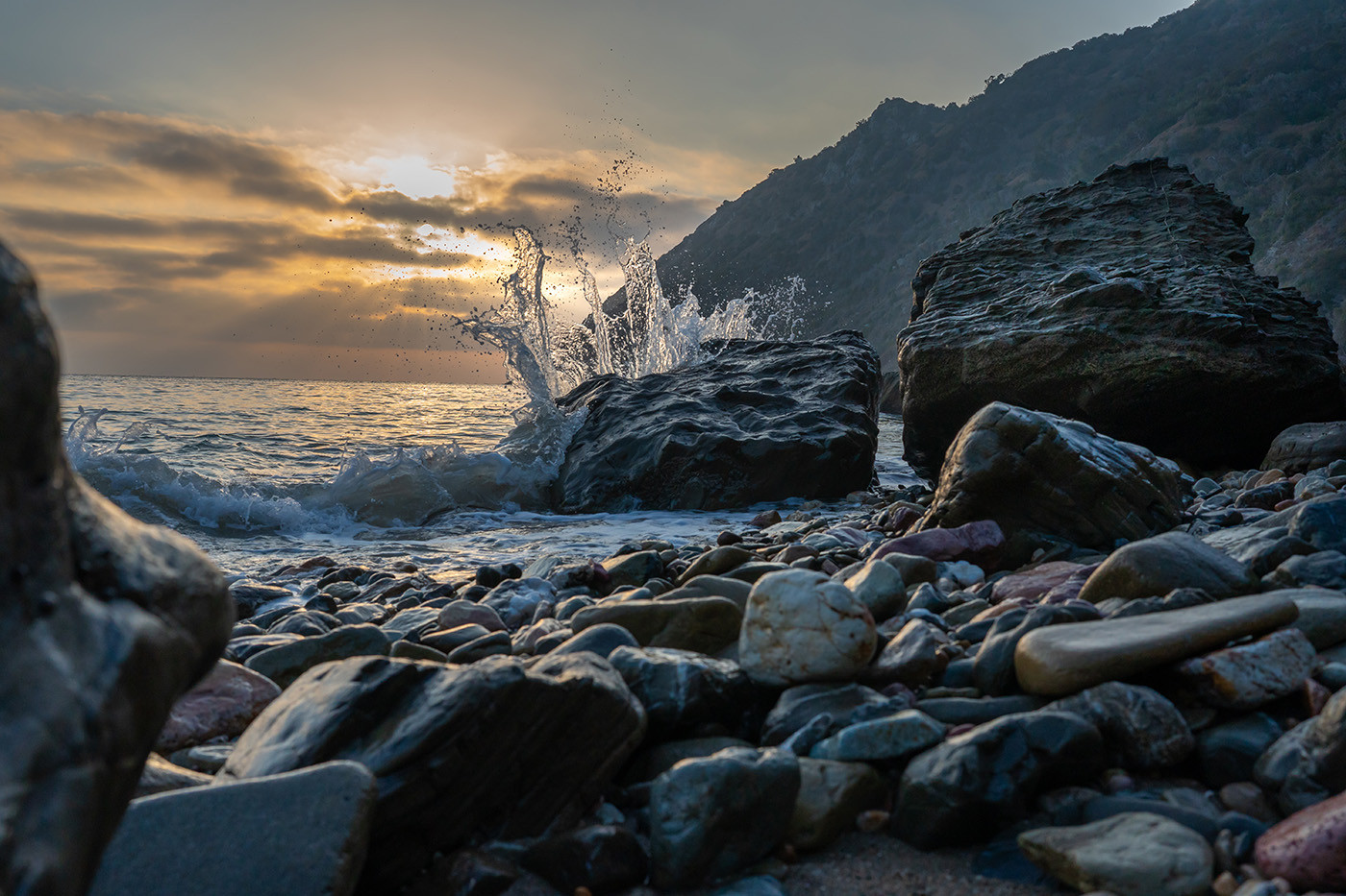 italian-gardens-wave.jpg Wave splashing over dark shoreline rocks at sunrise on Catalina Island